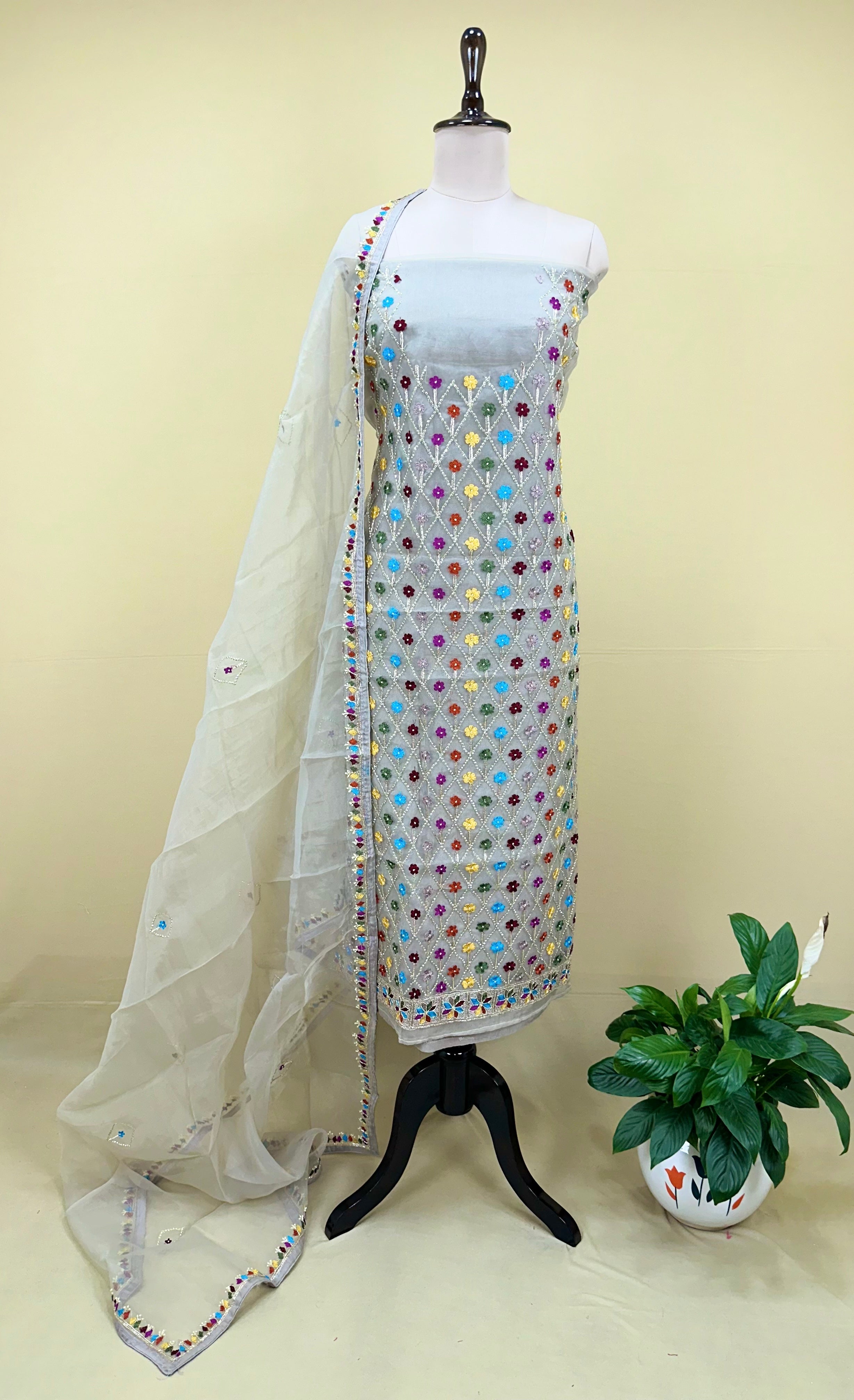 Grey Organza Featuring Intricate Geometric Patterns, Multicolored Floral Embroidery with Traditional Phulkari Work Unstitched Suit