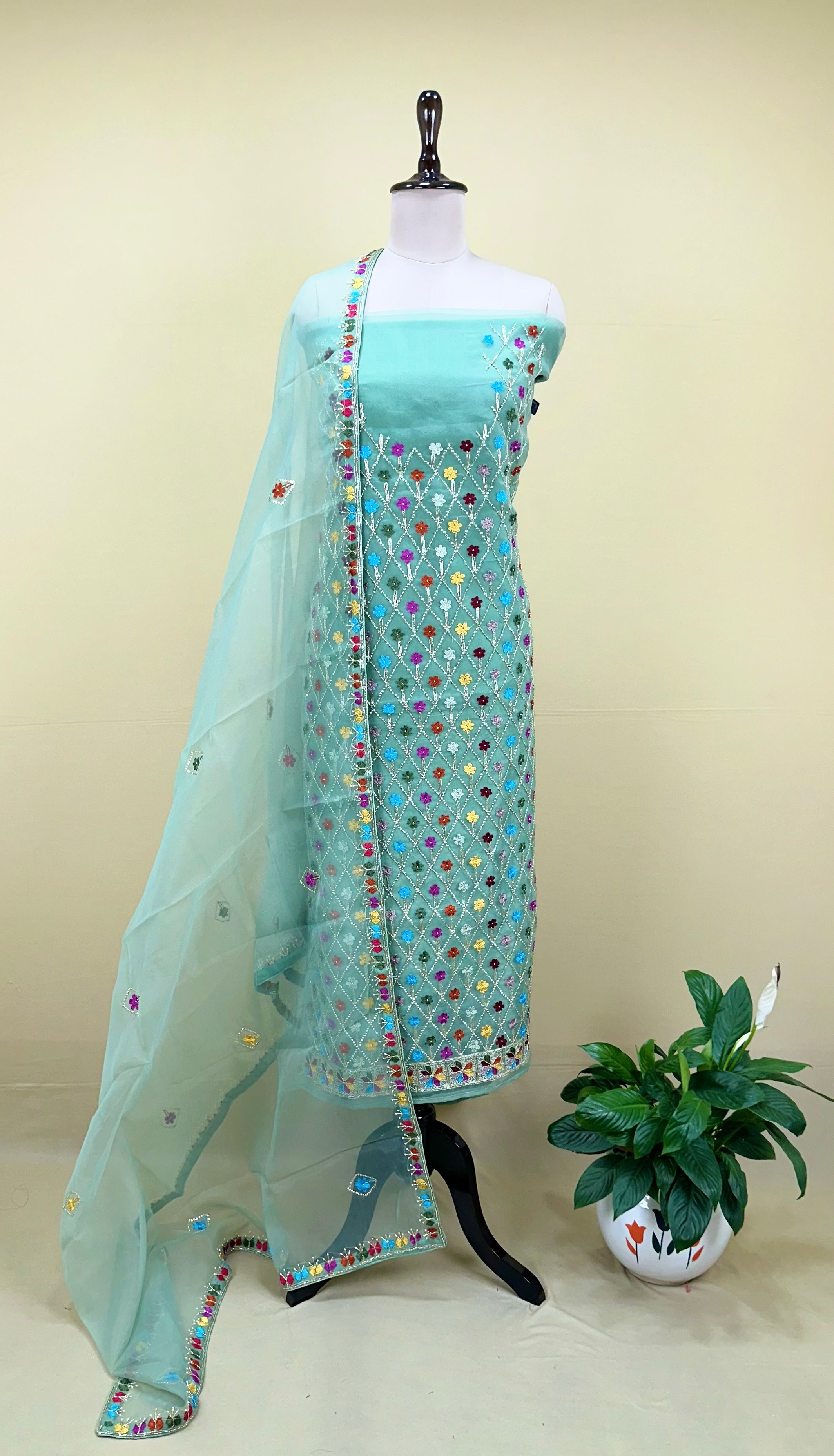 Green Organza Featuring Intricate Geometric Patterns, Multicolored Floral Embroidery with Traditional Phulkari Work Unstitched Suit