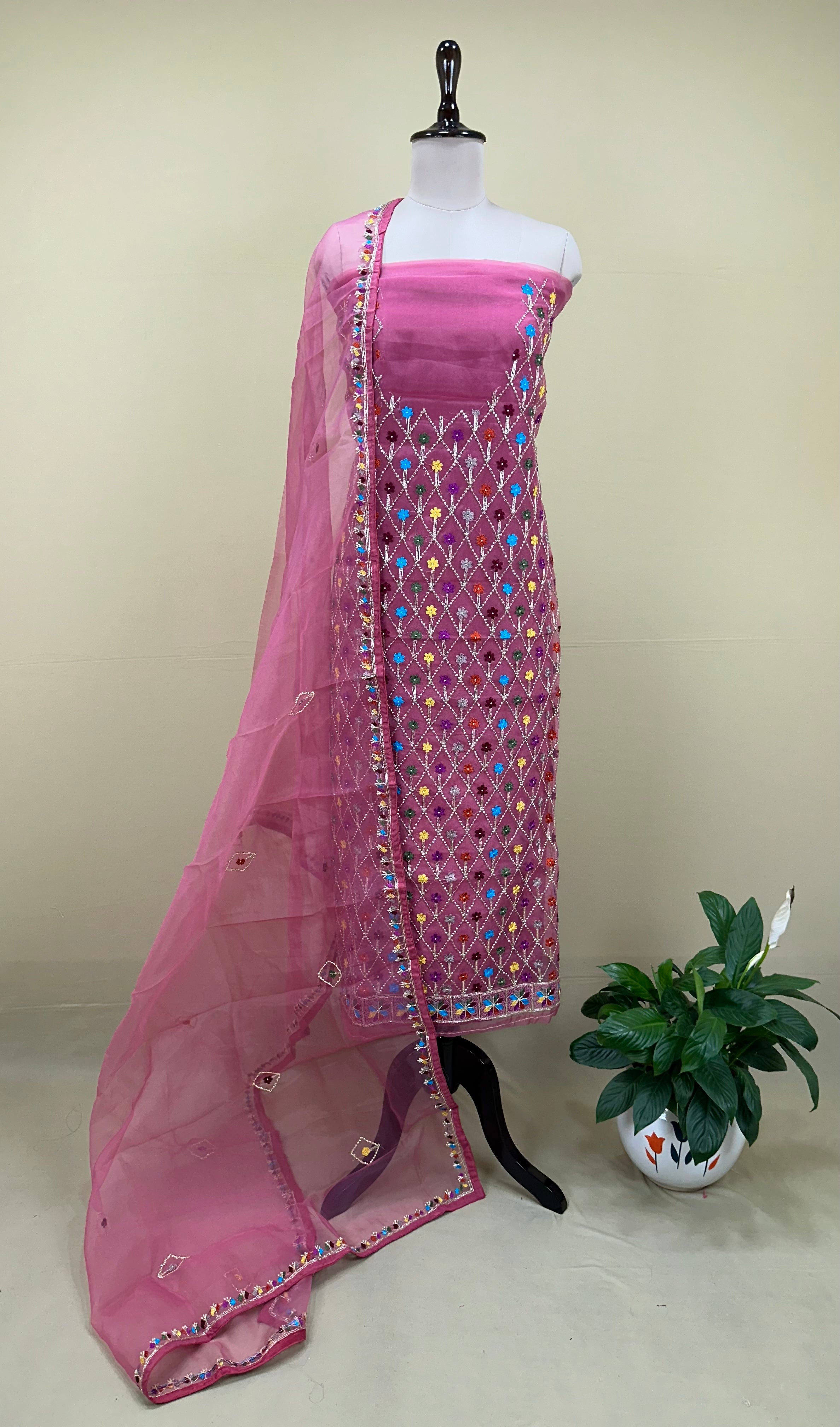 Pink Organza Featuring Intricate Geometric Patterns, Multicolored Floral Embroidery with Traditional Phulkari Work Unstitched Suit