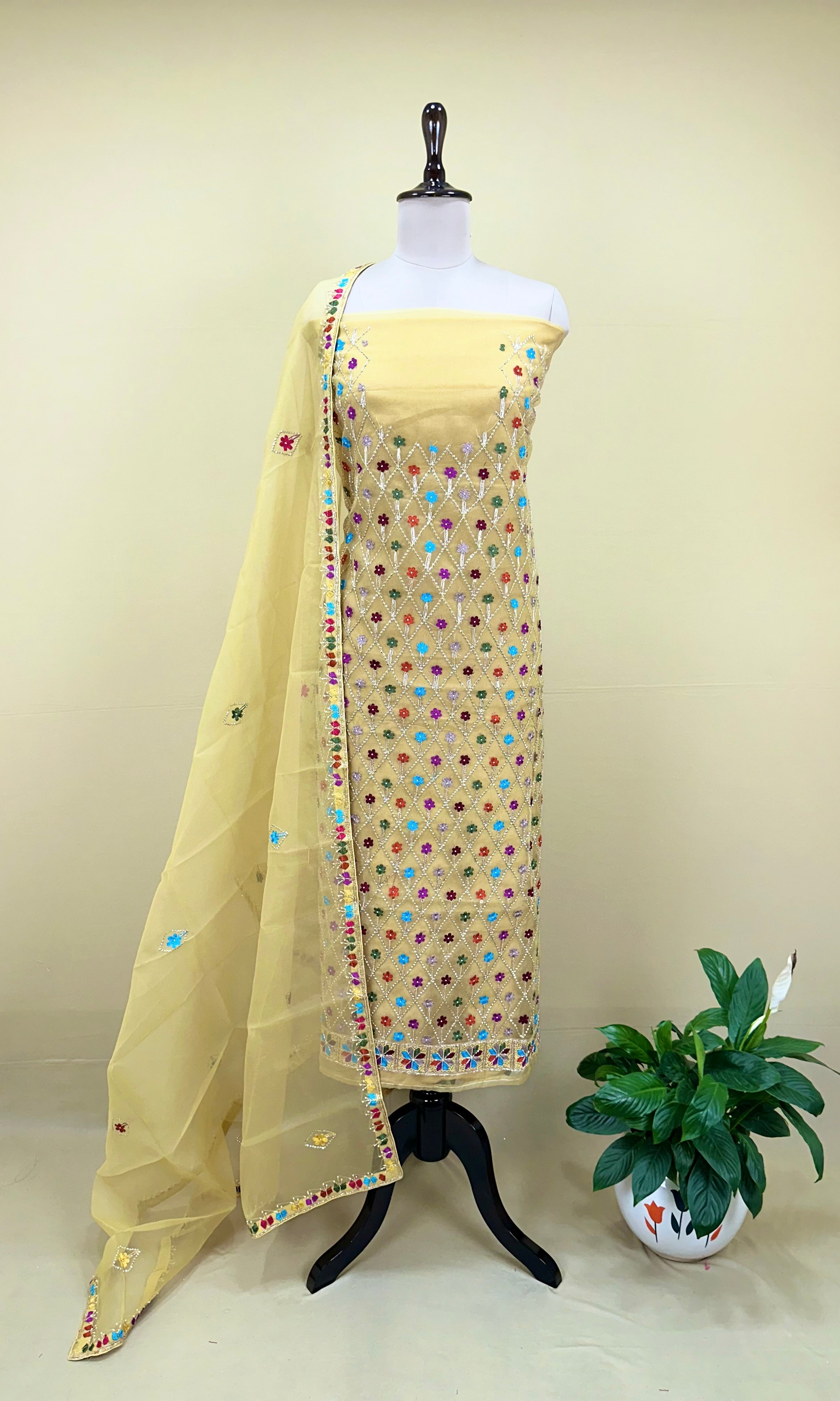 Yellow Organza Featuring Intricate Geometric Patterns, Multicolored Floral Embroidery with Traditional Phulkari Work Unstitched Suit