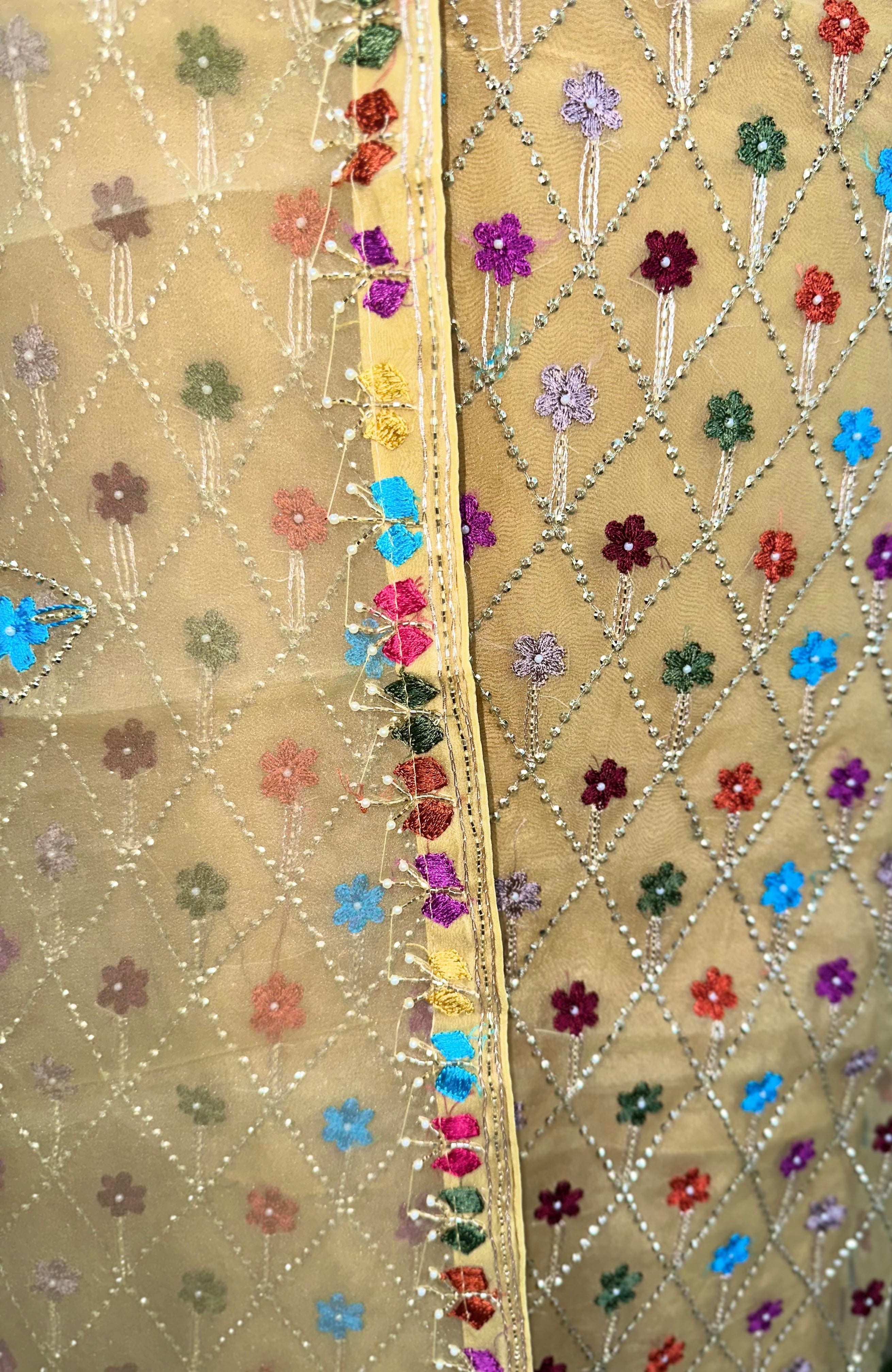 Yellow Organza Featuring Intricate Geometric Patterns, Multicolored Floral Embroidery with Traditional Phulkari Work Unstitched Suit