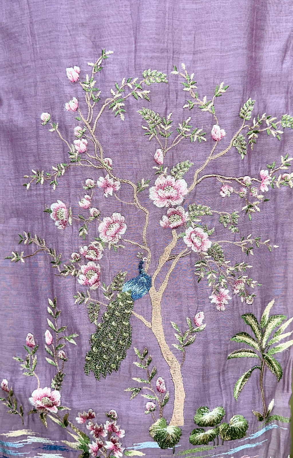 Purple Mal Chanderi Features Intricate Embroidery Depicting a Peacock and Floral Motifs, Characteristic of a Premium Indian Unstitched Suit