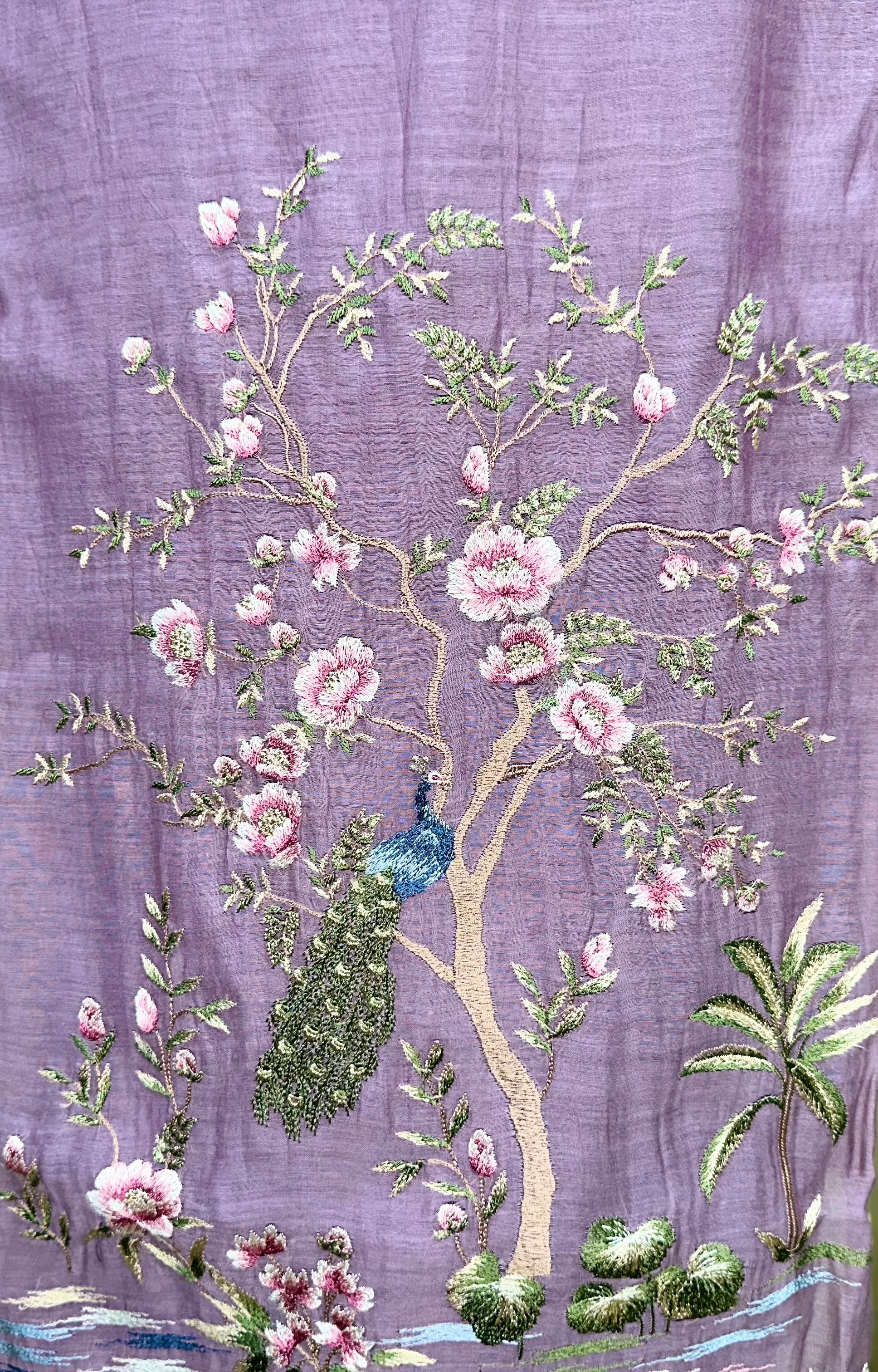 Purple Mal Chanderi Features Intricate Embroidery Depicting a Peacock and Floral Motifs, Characteristic of a Premium Indian Unstitched Suit