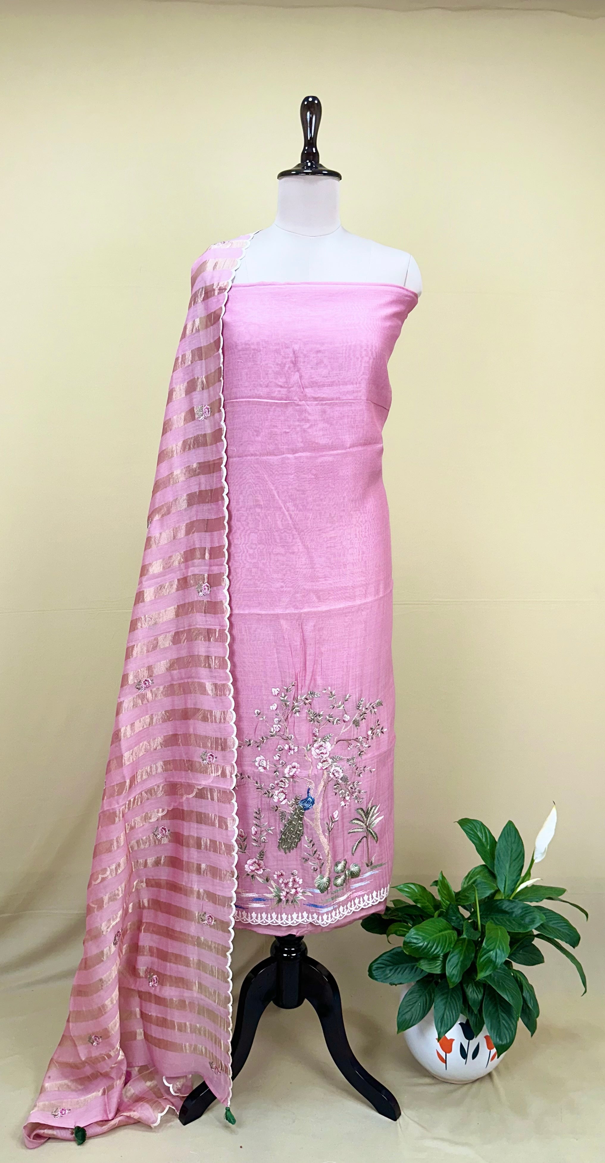 Pink Mal Chanderi Features Intricate Embroidery Depicting a Peacock and Floral Motifs, Characteristic of a Premium Indian Unstitched Suit