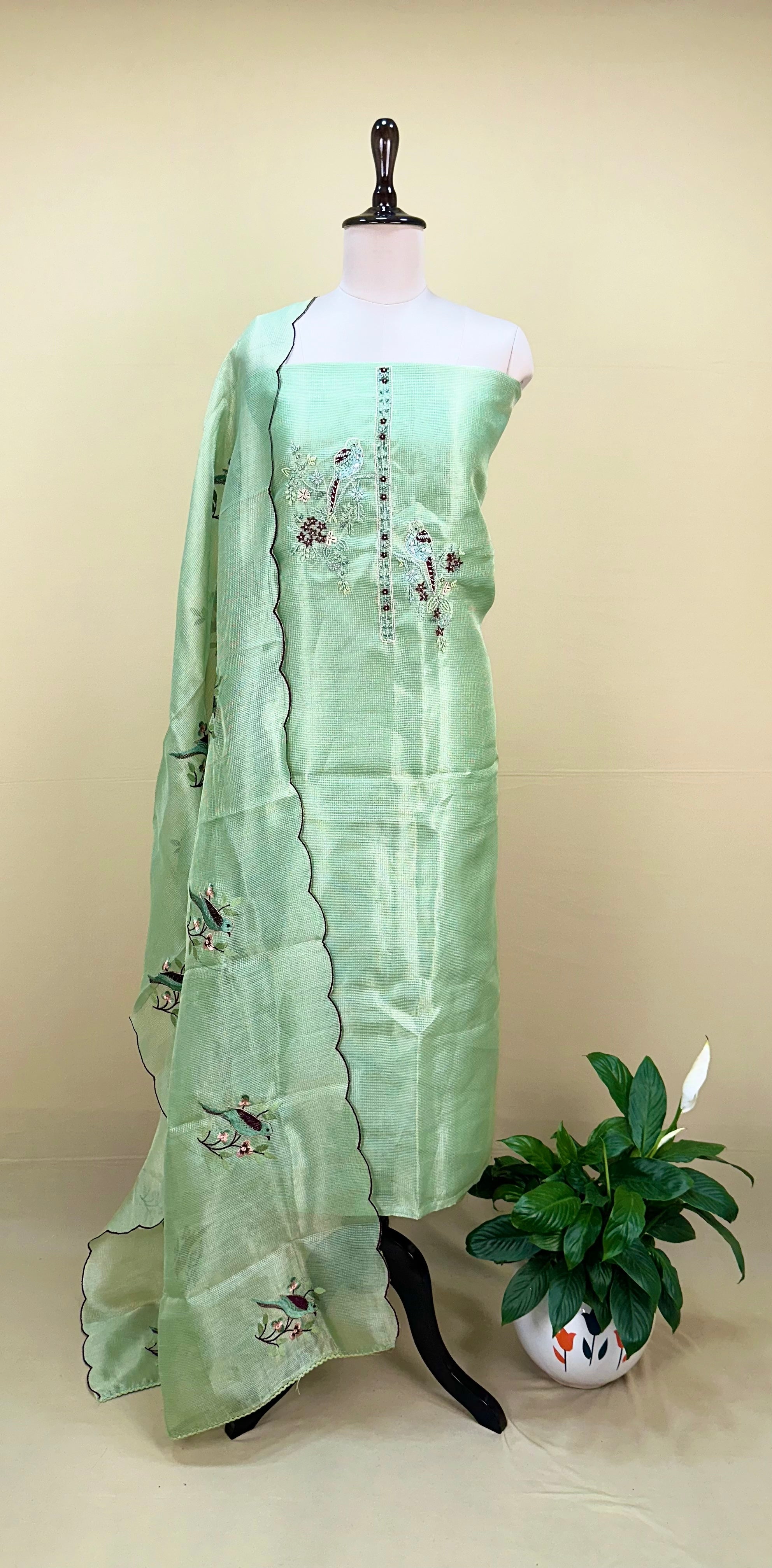 Green Kora Adorned with Intricate Embroidered Motifs Including a Bird and Floral Patterns, Commonly Crafted Using Techniques Like Zardosi and Kantha Work Unstitched Suit